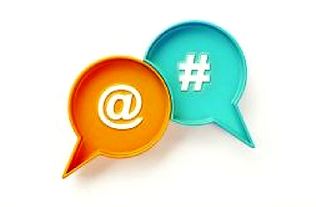Two dialogue marks, one in light orange and the other in turquoise, featuring an at symbol and a hashtag symbol.